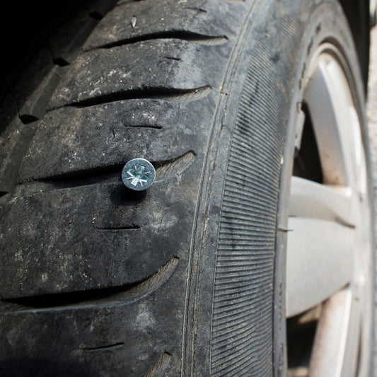Flat Tire Service - tire punctured by a screw.